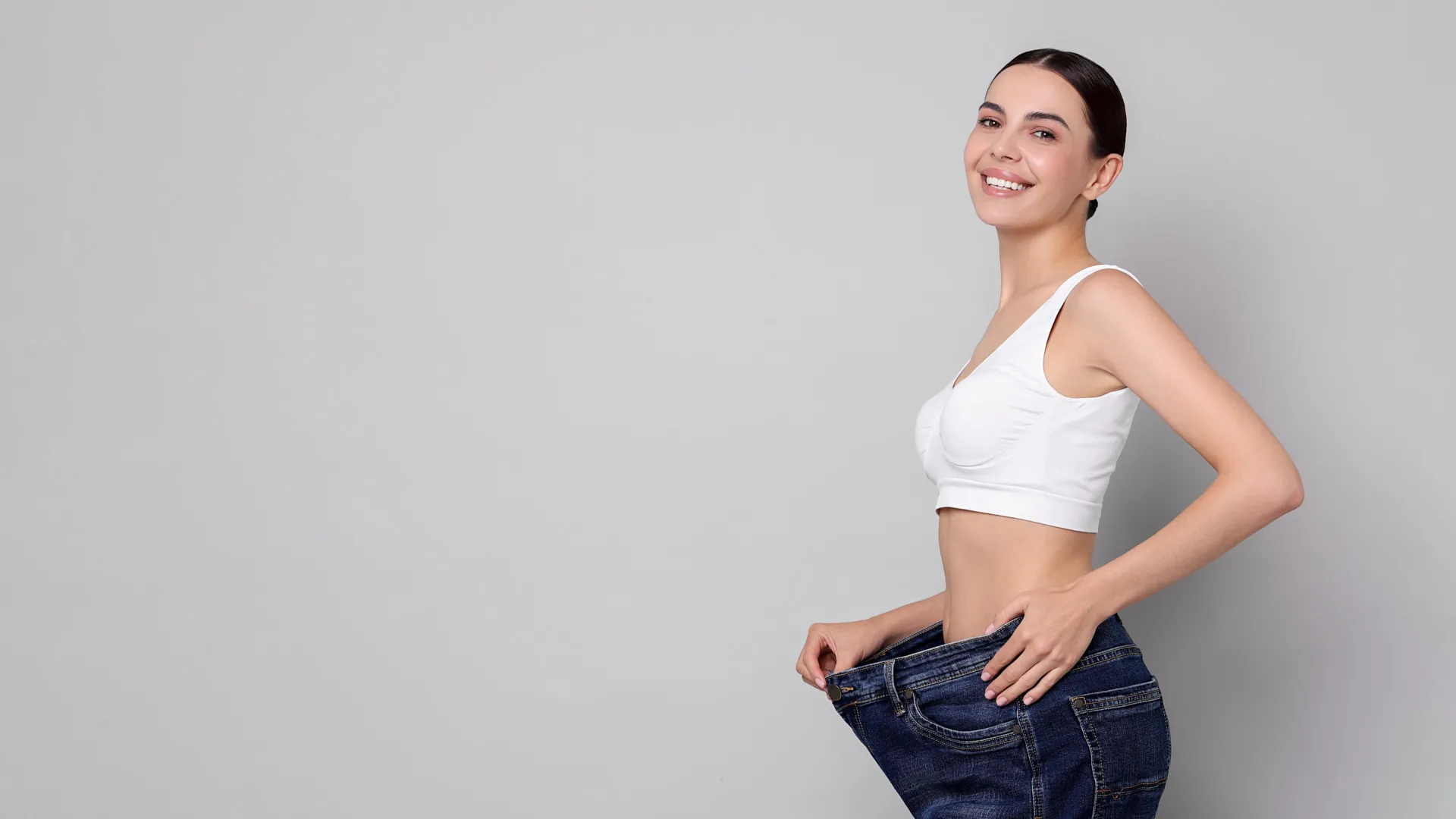 Woman celebrating weight loss results at iCRYO Grosse Pointe Medical Weight Loss program